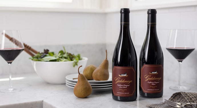 Goldeneye wines on a counter with wine and pears