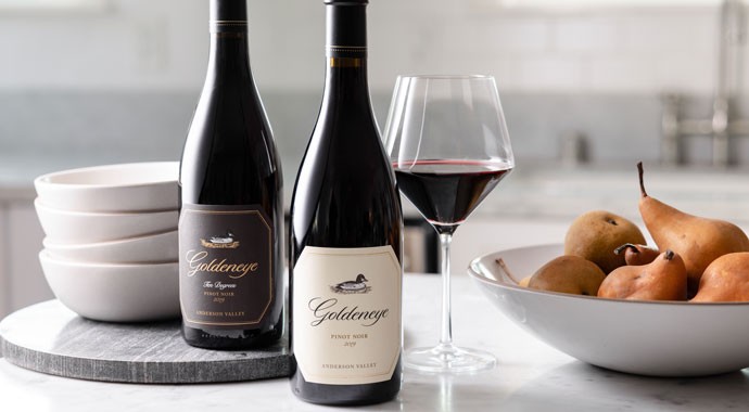 Goldeneye Pinot Noir on a table with pears