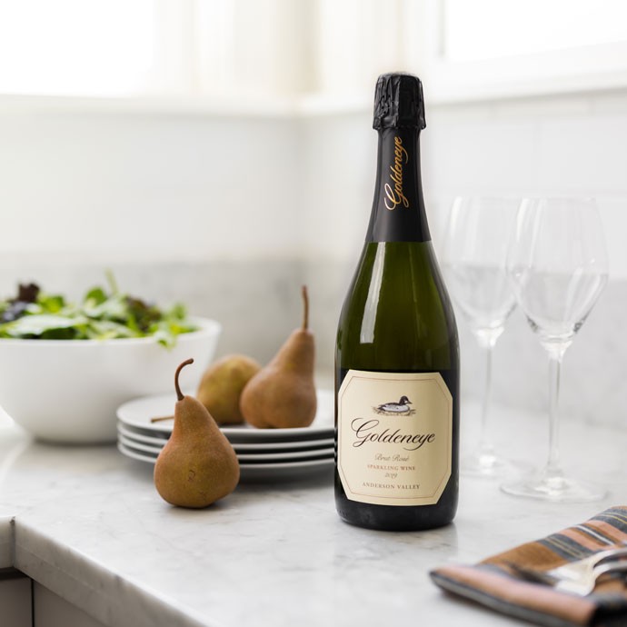 Goldeneye Sparkling wine on counter with pairs and salad